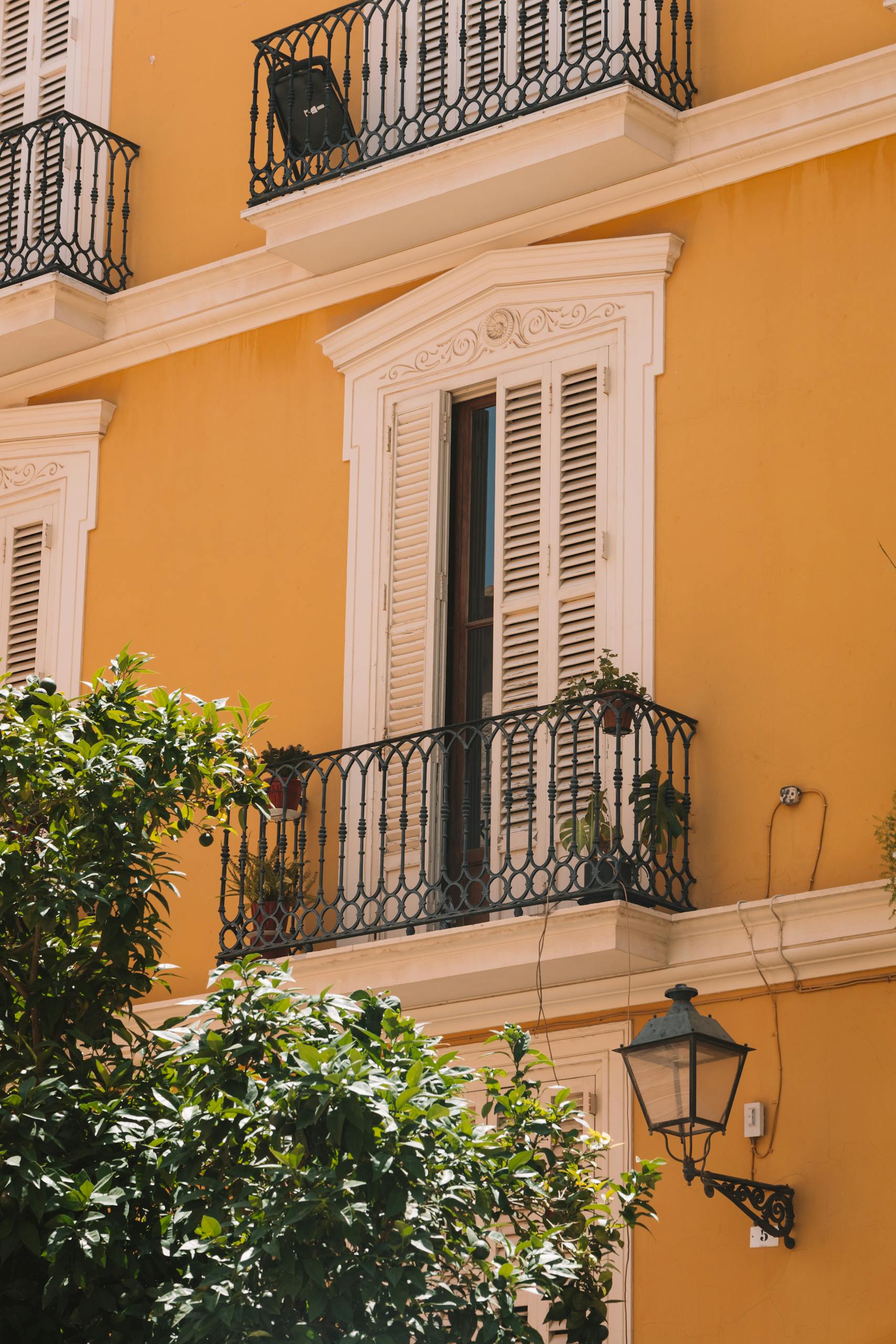 Exterior view of a neoclassic building façade with balconies in Valencia, Spain.